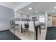 A clean kitchen features light-colored cabinets, black countertops and stainless steel appliances at 107 S Ocean Blvd. # 1002, Myrtle Beach, SC 29577