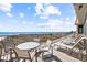 Spacious balcony with ocean views, perfect for relaxing and entertaining with tables and loungers at 1201 Trisail Ln, North Myrtle Beach, SC 29582