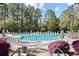 Resort-style community pool surrounded by lush landscaping and comfortable lounge chairs at 1201 Trisail Ln, North Myrtle Beach, SC 29582