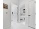 Bright hallway featuring access to bathroom and bedroom with modern white tile flooring at 1201 Trisail Ln, North Myrtle Beach, SC 29582