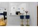 View of kitchen bar with stools next to dining area, with white cabinetry and modern appliances at 1201 Trisail Ln, North Myrtle Beach, SC 29582