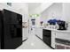 Bright kitchen with white cabinets and countertops, black appliances, and backyard access at 1201 Trisail Ln, North Myrtle Beach, SC 29582