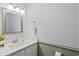 This classic powder room features a decorative mirror, vanity with a sink, and beadboard paneling at 128 Beaver Pond Loop # 48, Pawleys Island, SC 29585