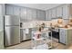 Modern kitchen showcasing stainless steel appliances, gray cabinetry, and sleek countertops at 128 Beaver Pond Loop # 48, Pawleys Island, SC 29585