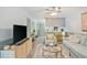 Comfortable seating is provided in this living room with a view into the kitchen with a breakfast bar at 128 Beaver Pond Loop # 48, Pawleys Island, SC 29585