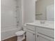 This well-lit bathroom includes a white vanity, toilet, and a shower-tub combination at 135 Harmony Ln., Myrtle Beach, SC 29588