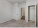 Bright bedroom features neutral carpet, an open closet, and an entry to another room at 135 Harmony Ln., Myrtle Beach, SC 29588