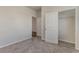 Comfortable carpeted bedroom featuring closet access and multiple doorways leading to other rooms at 135 Harmony Ln., Myrtle Beach, SC 29588