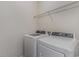 Bright laundry room features a washer, dryer, and a wire shelf for storage at 135 Harmony Ln., Myrtle Beach, SC 29588