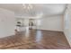 Open-concept living space showcasing wood floors, a modern kitchen with stainless steel appliances, and ample natural light at 135 Harmony Ln., Myrtle Beach, SC 29588