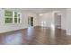 Bright living room featuring wood-look floors, a large window, sliding glass doors, and modern light fixture at 135 Harmony Ln., Myrtle Beach, SC 29588