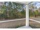 Relaxing screened-in porch overlooking a private backyard with mature trees at 135 Harmony Ln., Myrtle Beach, SC 29588