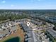 A bird's eye view of the neighborhood with lots of mature trees and a community lake at 135 Parmelee Dr. # A, Murrells Inlet, SC 29576