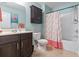 Bathroom with a flamingo theme including custom cabinet, and tub with flamingo curtain at 135 Parmelee Dr. # A, Murrells Inlet, SC 29576