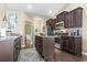 A view of an open concept kitchen featuring stainless steel appliances, dark wood cabinets, and granite countertops at 135 Parmelee Dr. # A, Murrells Inlet, SC 29576