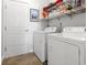 Practical laundry room with washer, dryer, shelving, and convenient access to storage at 135 Parmelee Dr. # A, Murrells Inlet, SC 29576