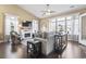 A modern living room featuring a fireplace, large windows, hardwood floors, and a ceiling fan at 135 Parmelee Dr. # A, Murrells Inlet, SC 29576