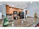 Functional kitchen with granite countertop, wooden cabinets, and modern appliances at 1352 Villa Marbella Ct. # 1-104, Myrtle Beach, SC 29572