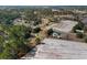 Extensive aerial view highlighting a house and outbuilding amid a community with lush tree cover and expansive fields at 140 Flag Patch Rd., Loris, SC 29569