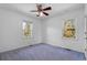 Bedroom with two windows, ceiling fan, and blue carpet at 140 Flag Patch Rd., Loris, SC 29569