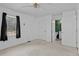 Bright bedroom with neutral carpet, ceiling fan, and an ensuite bathroom at 140 Flag Patch Rd., Loris, SC 29569