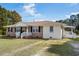 Charming single-story brick home with a covered front porch and well-maintained lawn at 140 Flag Patch Rd., Loris, SC 29569