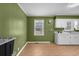 Functional kitchen space with vintage green walls, white cabinets, and ample countertop area at 140 Flag Patch Rd., Loris, SC 29569