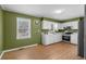 Practical kitchen featuring painted green walls, white cabinets, and ample countertop space at 140 Flag Patch Rd., Loris, SC 29569