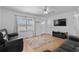 Cozy living room featuring hardwood floors, a ceiling fan, and a mounted TV at 140 Flag Patch Rd., Loris, SC 29569