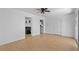 Living room with a ceiling fan, wood grain floors, and doors leading to other rooms in the home at 140 Flag Patch Rd., Loris, SC 29569