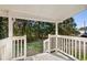 Covered back porch with view of wooded back yard and a white railing and trim at 140 Flag Patch Rd., Loris, SC 29569