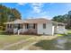 Charming single-story home featuring a brick and siding exterior with a quaint front porch at 140 Flag Patch Rd., Loris, SC 29569