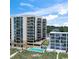 Aerial view of a beachfront condominium complex with a pool and beautiful landscaping at 1425 S Ocean Blvd. # 8-B, North Myrtle Beach, SC 29582