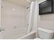 Bright bathroom featuring white tile, a shower-tub combo, and a black medicine cabinet above the toilet at 1425 S Ocean Blvd. # 8-B, North Myrtle Beach, SC 29582