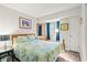 Cozy bedroom featuring a floral-patterned quilt, wood-framed mirror and artwork, and ample natural light at 1425 S Ocean Blvd. # 8-B, North Myrtle Beach, SC 29582