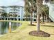 Exterior view of the property's lush landscaping and scenic pond at 14290 Ocean Highway # 207, Pawleys Island, SC 29585