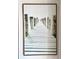 Framed art of dock pilings set in water at 14290 Ocean Highway # 207, Pawleys Island, SC 29585