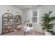 Well-lit home office with a clear desk, decorative shelving, and a relaxing plant at 1494 Nokota Dr., Conway, SC 29526