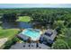 Aerial shot of the community pool and pool house, overlooking the golf course and lakes at 178 Clubhouse Dr. # 3, Sunset Beach, NC 28468