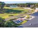 Aerial view of a golf course and outdoor patio seating area at 178 Clubhouse Dr. # 3, Sunset Beach, NC 28468