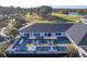 Aerial view of a clubhouse with patio seating area and golf course at 178 Clubhouse Dr. # 3, Sunset Beach, NC 28468