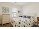 Well-lit bedroom with woven furniture and beautiful floral bedding at 178 Clubhouse Dr. # 3, Sunset Beach, NC 28468