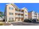 Inviting condo exterior features double balconies, complementary landscaping, and convenient parking at 178 Clubhouse Dr. # 3, Sunset Beach, NC 28468