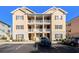 Inviting condo exterior features double balconies, complementary landscaping, and convenient parking at 178 Clubhouse Dr. # 3, Sunset Beach, NC 28468