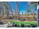 View of a natural backyard, with trees and grass, from the partially covered back porch at 179 Heath Dr., Longs, SC 29568