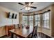 Cozy dining area featuring a wooden table, natural light, and a ceiling fan at 179 Heath Dr., Longs, SC 29568