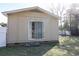 Back of house with sliding glass door and small patio with a green lawn at 1841 Jasper St., Georgetown, SC 29440