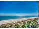 Expansive view of the beach and ocean, with palm trees, clear blue sky, and white sand at 2006 N Ocean Blvd. # 876, Myrtle Beach, SC 29577