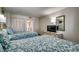 Cozy bedroom with two beds, floral bedding, and neutral decor at 2006 N Ocean Blvd. # 876, Myrtle Beach, SC 29577