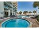 Outdoor pools and hot tub are surrounded by palm trees at 2006 N Ocean Blvd. # 876, Myrtle Beach, SC 29577